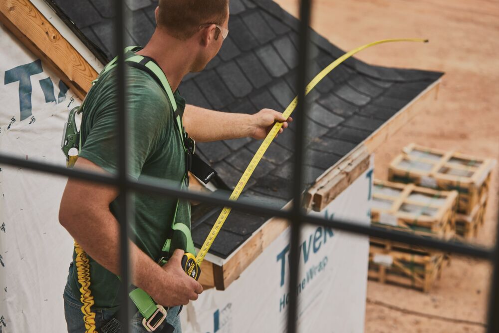 35 foot FATMAX classic tape measure being used by a person to measure roof side.