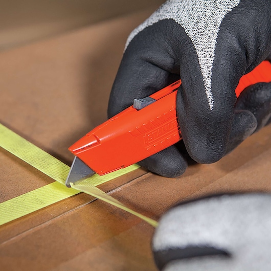 Self retracting safety utility knife cutting tape.