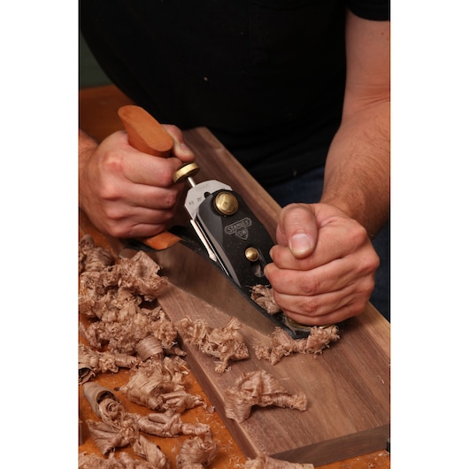 Number 4 sweetheart smoothing bench plane smoothing wooden surface.