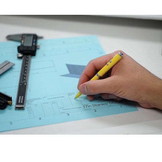 Multi function pen with stylus laser and L E D flash light in use.