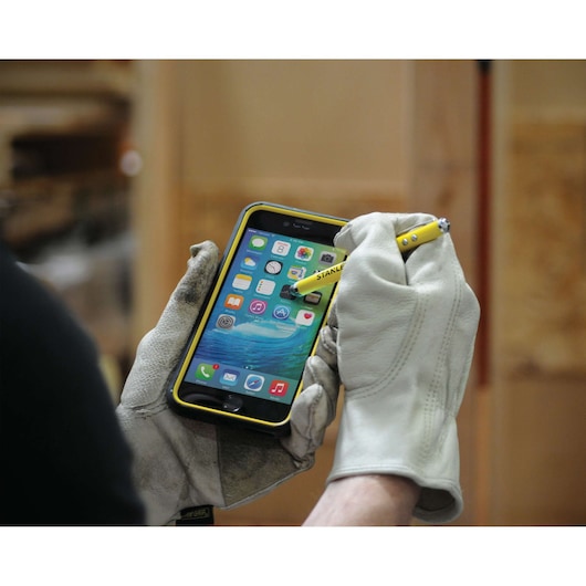 Multi function pen with stylus laser and L E D flash light being used.