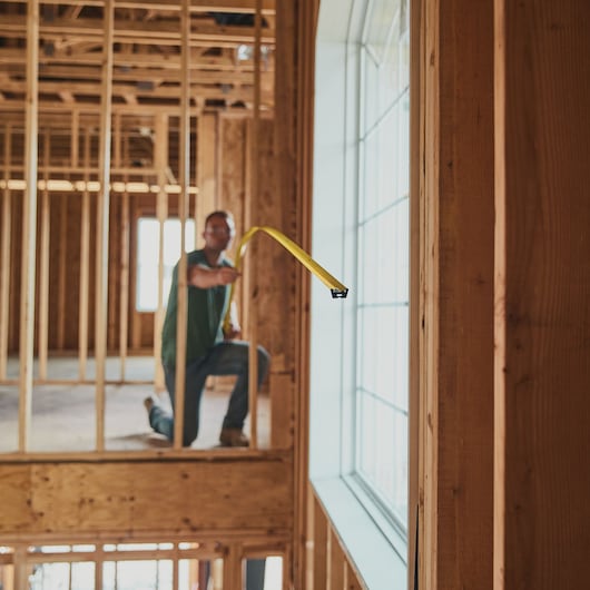 25 foot FATMAX classic tape measure being used by a person to measure distance.