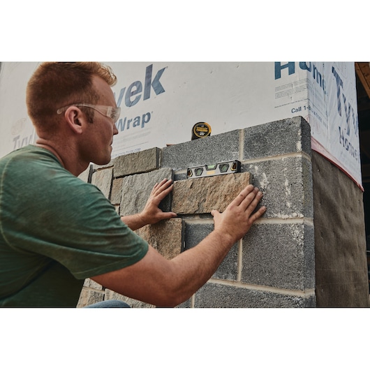 25 foot FATMAX classic tape measure being used by a person.