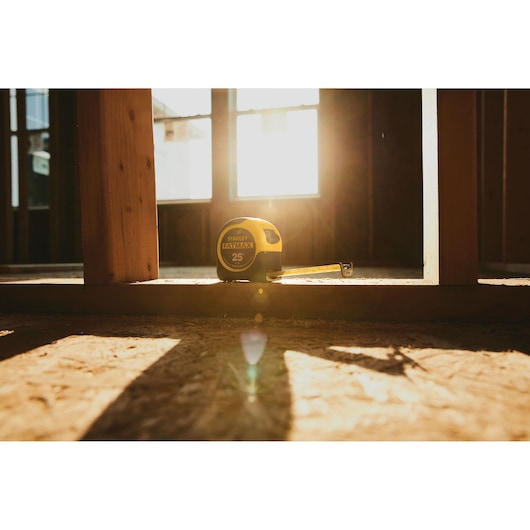 25 foot FATMAX classic tape measure placed on the floor of construction site.