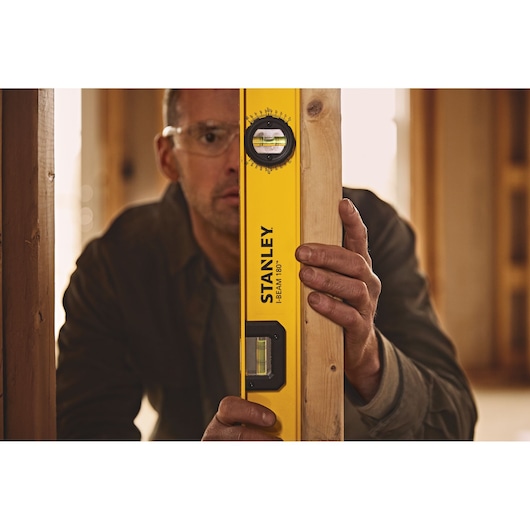 24 inch I beam 180 level being used to level piece of wood.