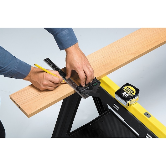 12 inch plastic handle english combination square being used.