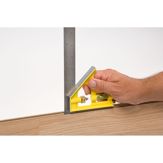 16 inch english combination square being used.