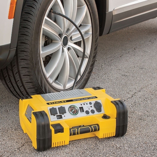 500 Instant and 1000 PEAK Battery AMP PROFESSIONAL POWER STATION being used to inflate car tire.