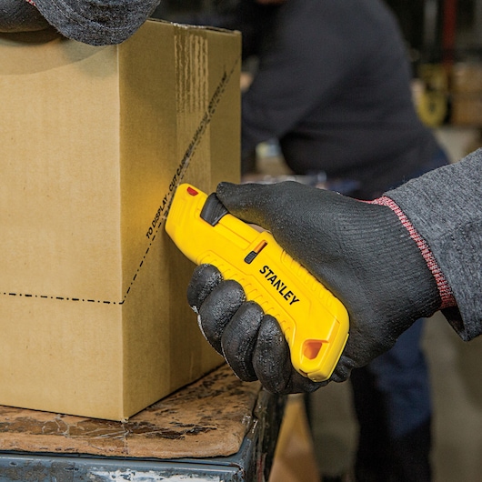 Tri Slide Safety Knife being used for cutting cardboard box.