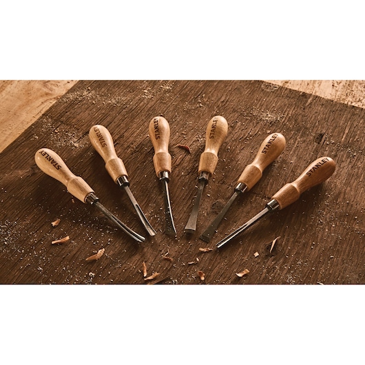 6 piece Wood Carving Tool Set placed on wood.