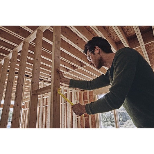 15 inch Chisel End Nail Puller being used by person to pull nail out of wood.