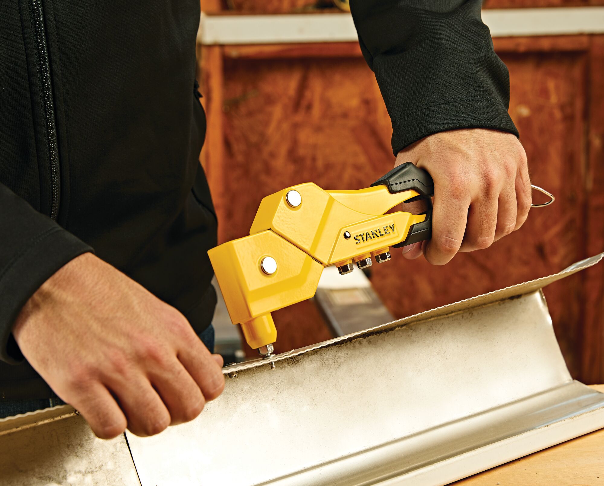 Swivel head riveter being used by a person.