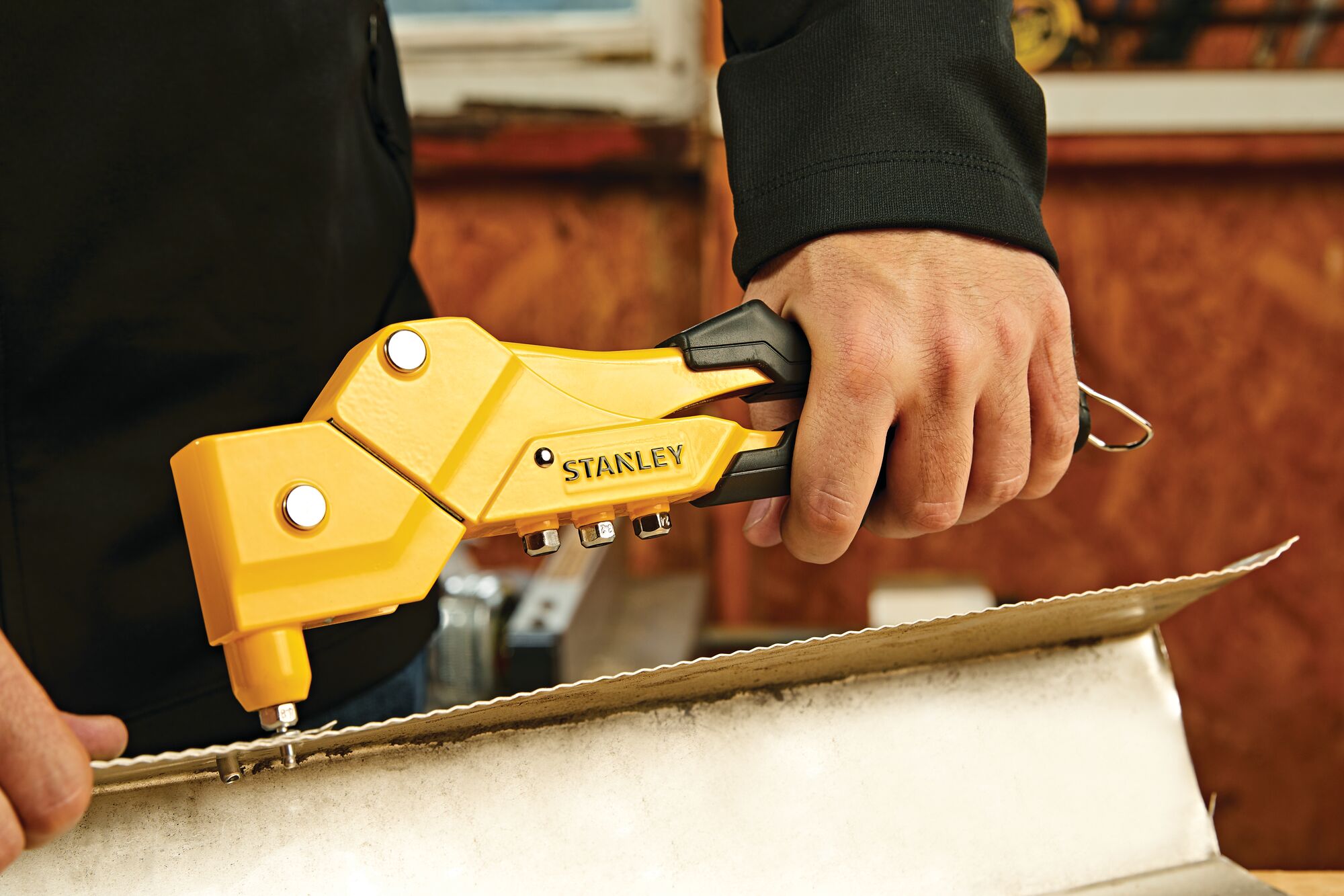 Swivel head riveter being used by a person.