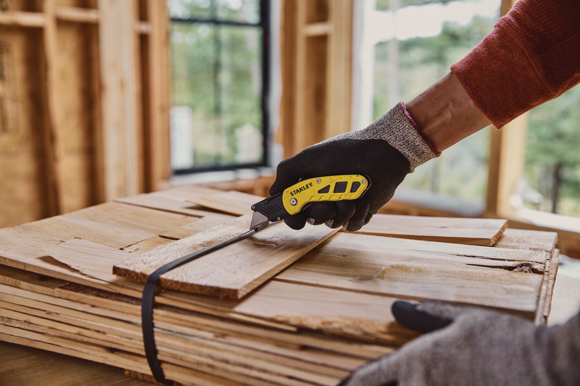 COMPACT FIXED BLADE FOLDING UTILITY KNIFE being used for cutting.