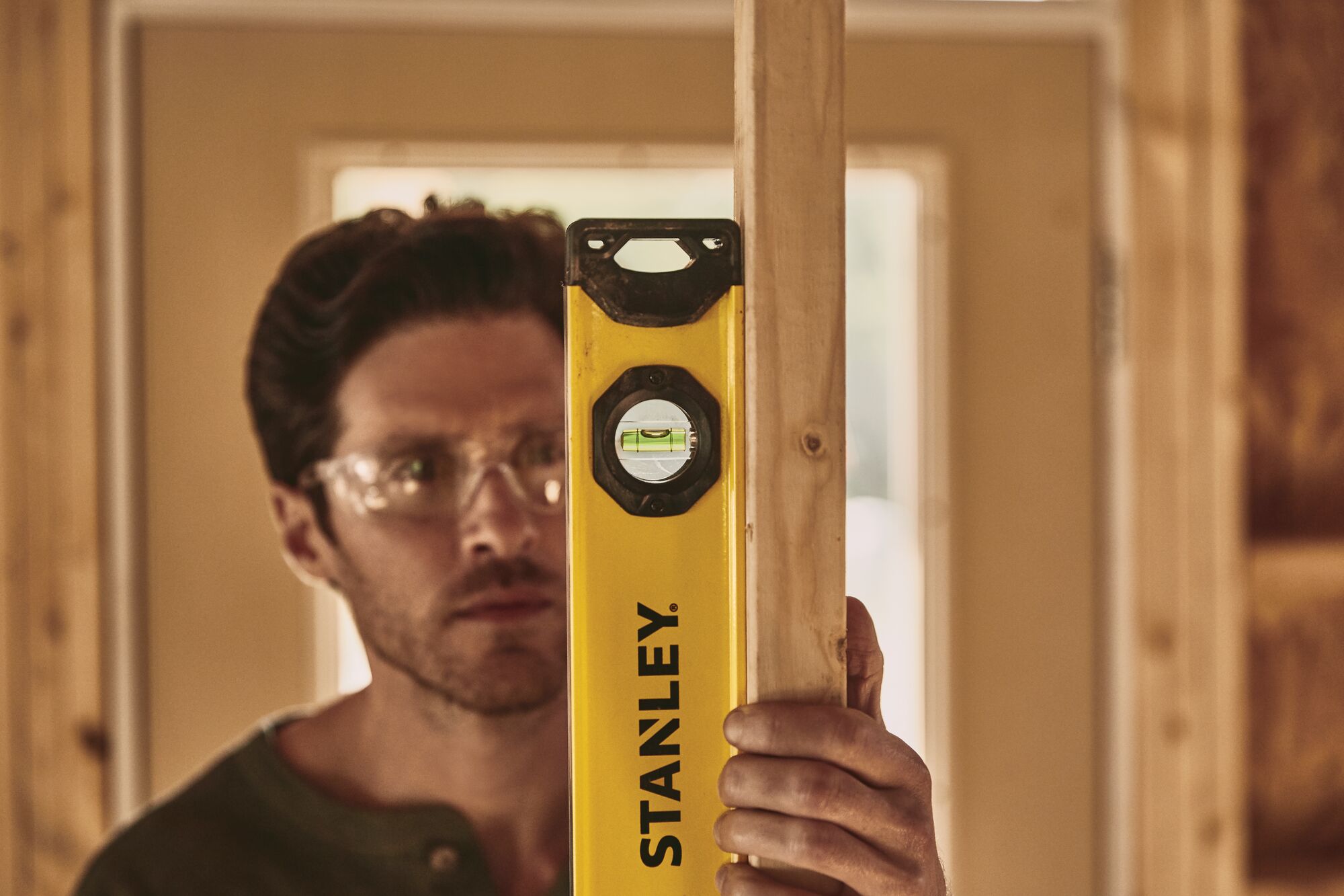 24 inch Box Beam Level in use by person.